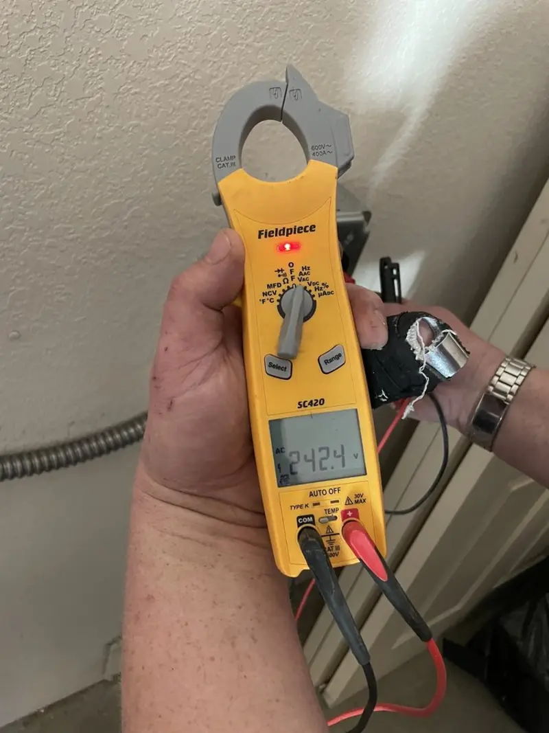 Voltage testing with clamp meter during Electrical Installation Services in Vinton